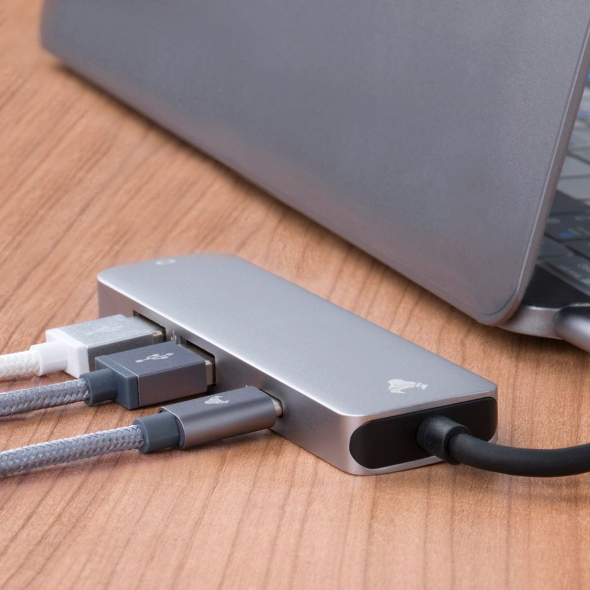 A USB hub with cables plugged into a laptop